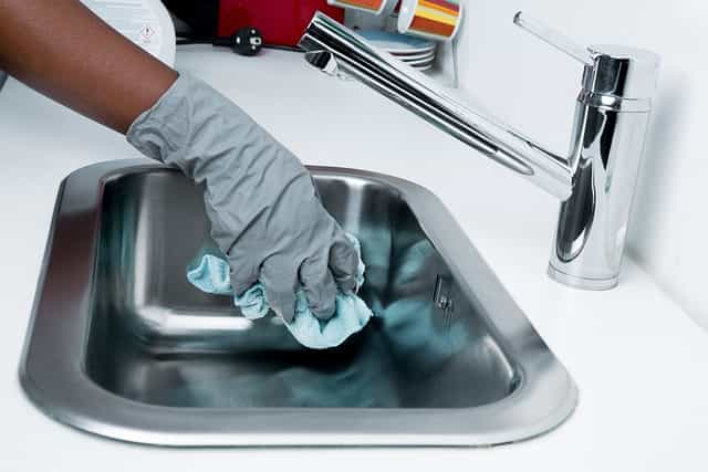 Person cleaning sink