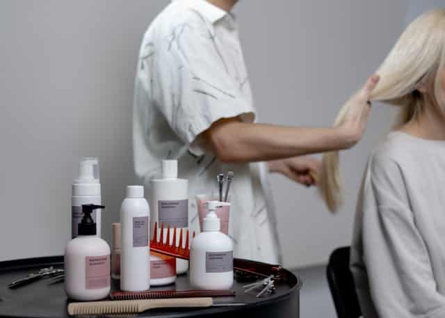 A person applying hair products